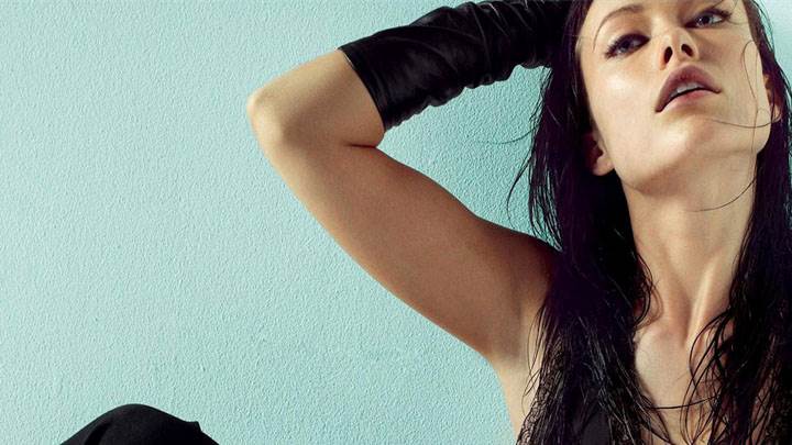 Olivia Wilde Sitting Pose In Black Dress Photoshoot